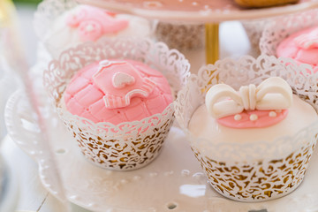 dessert table with flowers and cupcakes for maternity event 