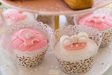 dessert table with flowers and cupcakes for maternity event 