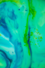 Fototapeta na wymiar Blue and Green Wispy Color on Water Soft, gentle, relaxing swirls. Flowing colors draw you in and calm you.