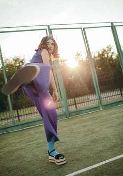 Teen girl kickboxing at camera