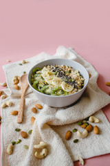 healthy Breakfast of oatmeal with fruit on a white napkin and almond