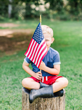 Little boy holding American flag