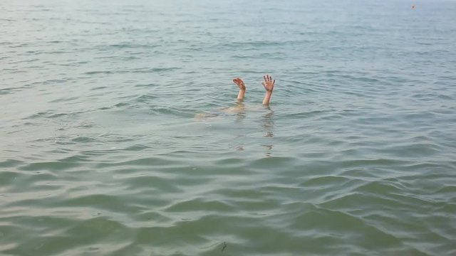 man swimming in the sea, rest on the water