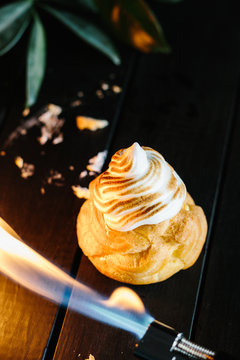 Cream Puff with Vanilla Pudding and Meringue Frosting Being Torched