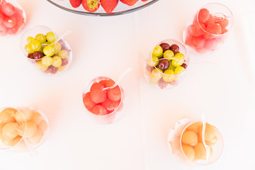 spring / summer appetizer table with fresh fruit cocktails 