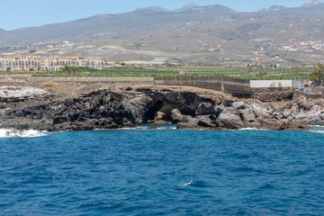 Beautiful rocks at beach with waves and blue water in Teneriffa