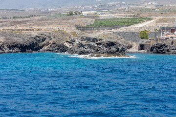 Beautiful rocks at beach with waves and blue water in Teneriffa