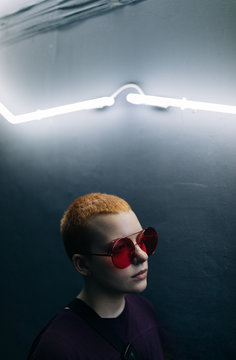 young androgyne woman with short hair , neon light