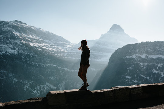 Woman walking along ledge