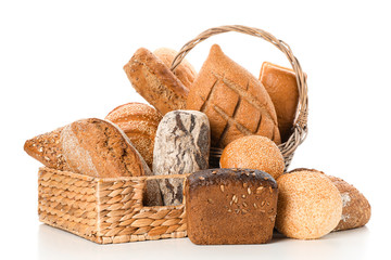 Bakery products in straw basket isolated on white background