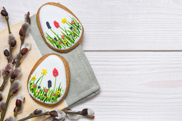 Easter gingerbread set and willow twig on white wooden background.  Easter  eggs  gingerbread