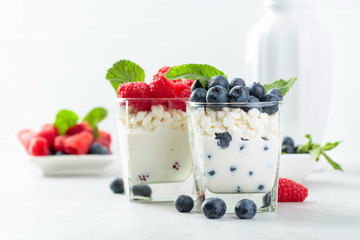 Cottage cheese with cream, raspberry and blueberry garnished with fresh mint.