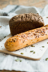 Freshly baked bread on dark grey fabric with seed