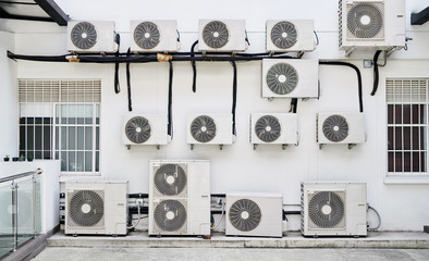 Large amounts of air conditioning units on a wall