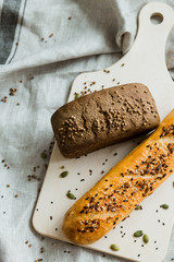 Freshly baked bread on dark grey fabric with seed