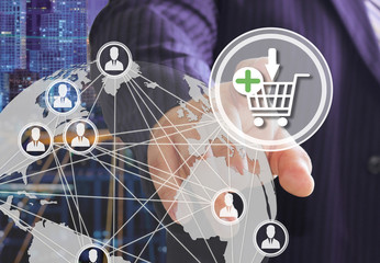 The businessman chooses on the shopping cart on the touch screen with a futuristic background.The concept of online . Auctions.online store. Shopping cart icon. Ecommerce.