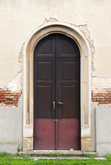 Fototapeta na wymiar Door of old neglected church in Ecka