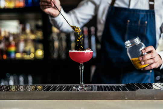 Unrecognizable professional young bartender working