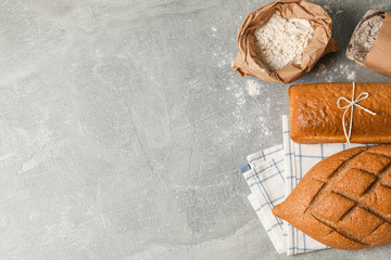 Bakery products composition on grey background, top view and space for text