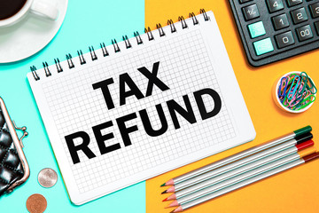  TAX REFUND with the office tools on yellow blue background . Concept TAX REFUND