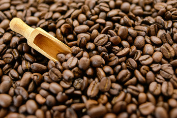Roasted coffee beans on rustic wooden table background