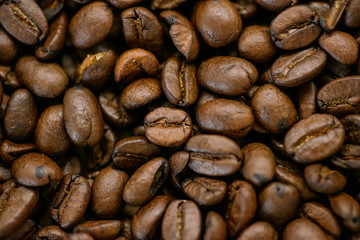 Roasted coffee beans on rustic wooden table background