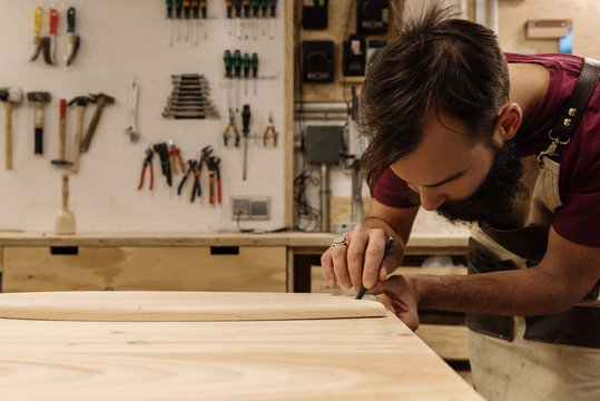 Man encircling wood piece