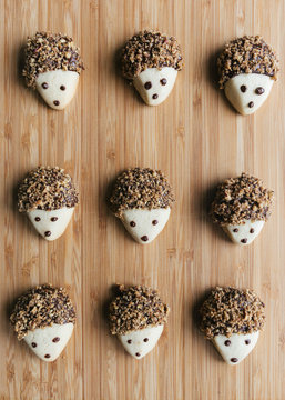 Pecan and dark chocolate covered hedgehog cookies on wooden tray