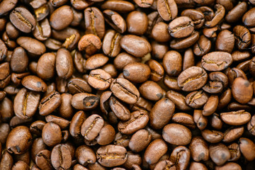 Roasted coffee beans on rustic wooden table background