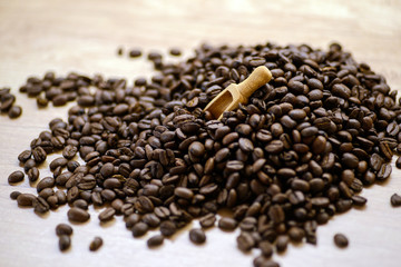 Roasted coffee beans on rustic wooden table background