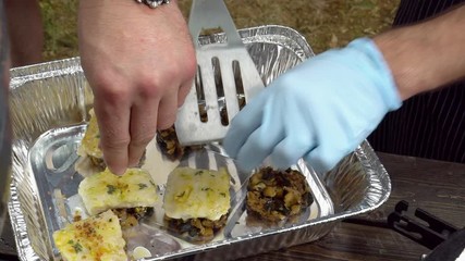 hand put spice on minced mushrooms and fish. Slow motion shot