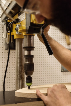 Craftsman using drilling machine on deck