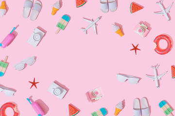 Creative composition made with various travel objects on pastel pink background. Summer vacation pattern.