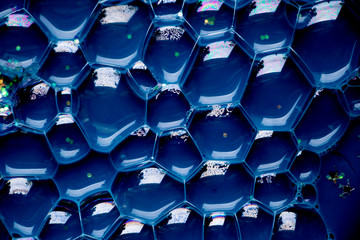Blue Bubble Cells Background Texture.  Hive like pattern with a deep blue background. Interesting texture full of hexagons.
