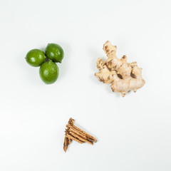 Ginger root with lemon and cinnamon photo on neutral background