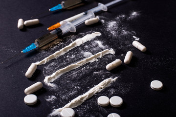 Hard drugs on dark table. heroin, cocaine, amphetamine, ecstasy, pills and more. Creative idea. Drugs. Sad. Die. Illness