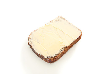 Rye bread piece with butter isolated on white background. Bakery products