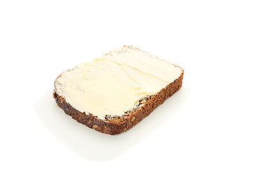 Rye bread piece with butter isolated on white background. Bakery products