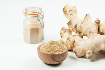 Fresh roots and ginger powder - Zingiber officinale; photo on neutral background