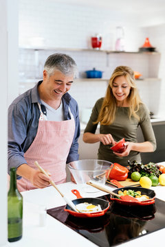 Married couple cooking together at home