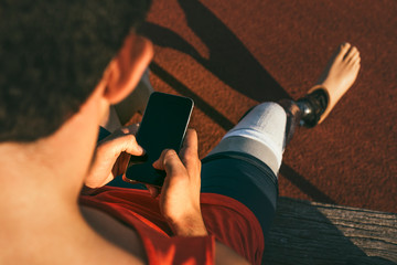 Portrait Of Disabled Man Athlete With Leg Prosthesis using a sma