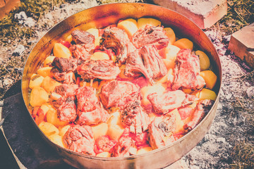 Lamb meat, potatoes and vegetables cooked on a grill, Serbian dish 