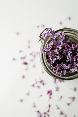 Obraz na płótnie Canvas Purple healthy smoothie breakfast in a glass jar with lilac flowers