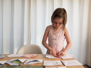 Girl preparing invitation cards.