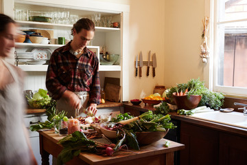 Couple cooking dinner in their rustic kitchen