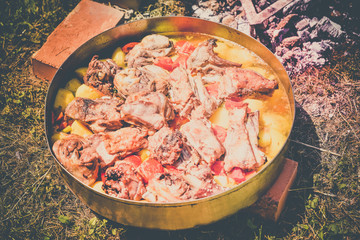 Lamb meat, potatoes and vegetables cooked on a grill, Serbian dish 