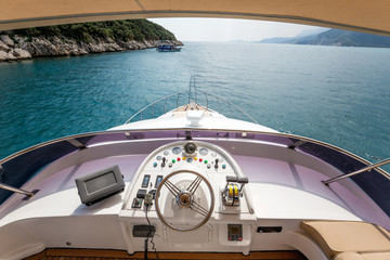 Fototapeta na wymiar Steering wheel on a luxury yacht cabin