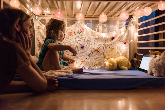 Little girl with father watching tablet
