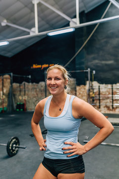 Muscular woman looking at camera in gym