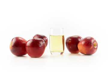 five apples and a glass of apple juice